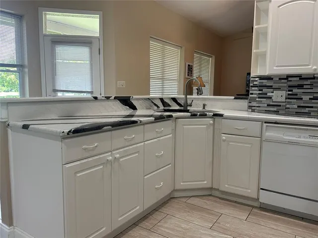 a spacious bedroom with a bed and a table in it