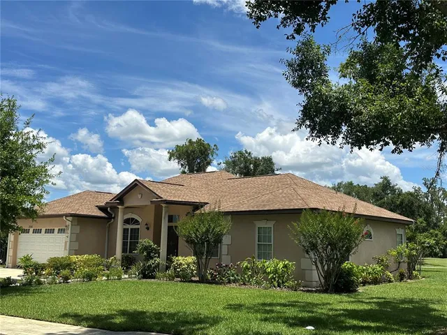 a view of a house with a yard and a garden