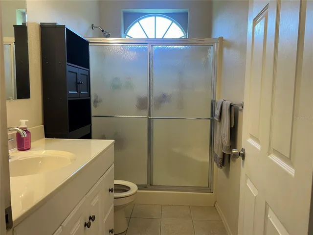 a bedroom with a bed and a television