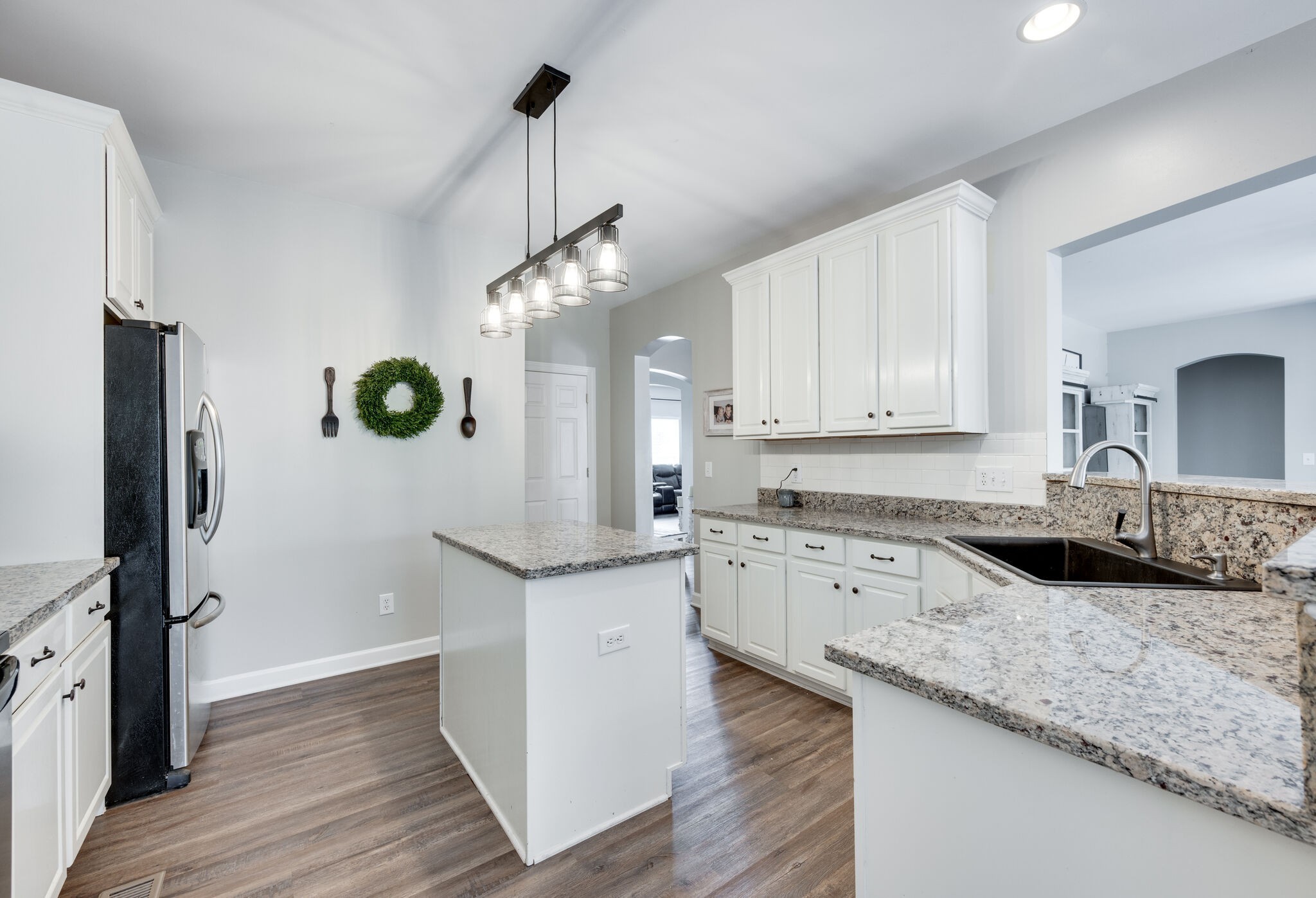 2047 Belshire Way Spring Hill, TN 37174 - Photo 23 of 54 a kitchen with granite countertop cabinets stainless steel appliances and a wooden floor