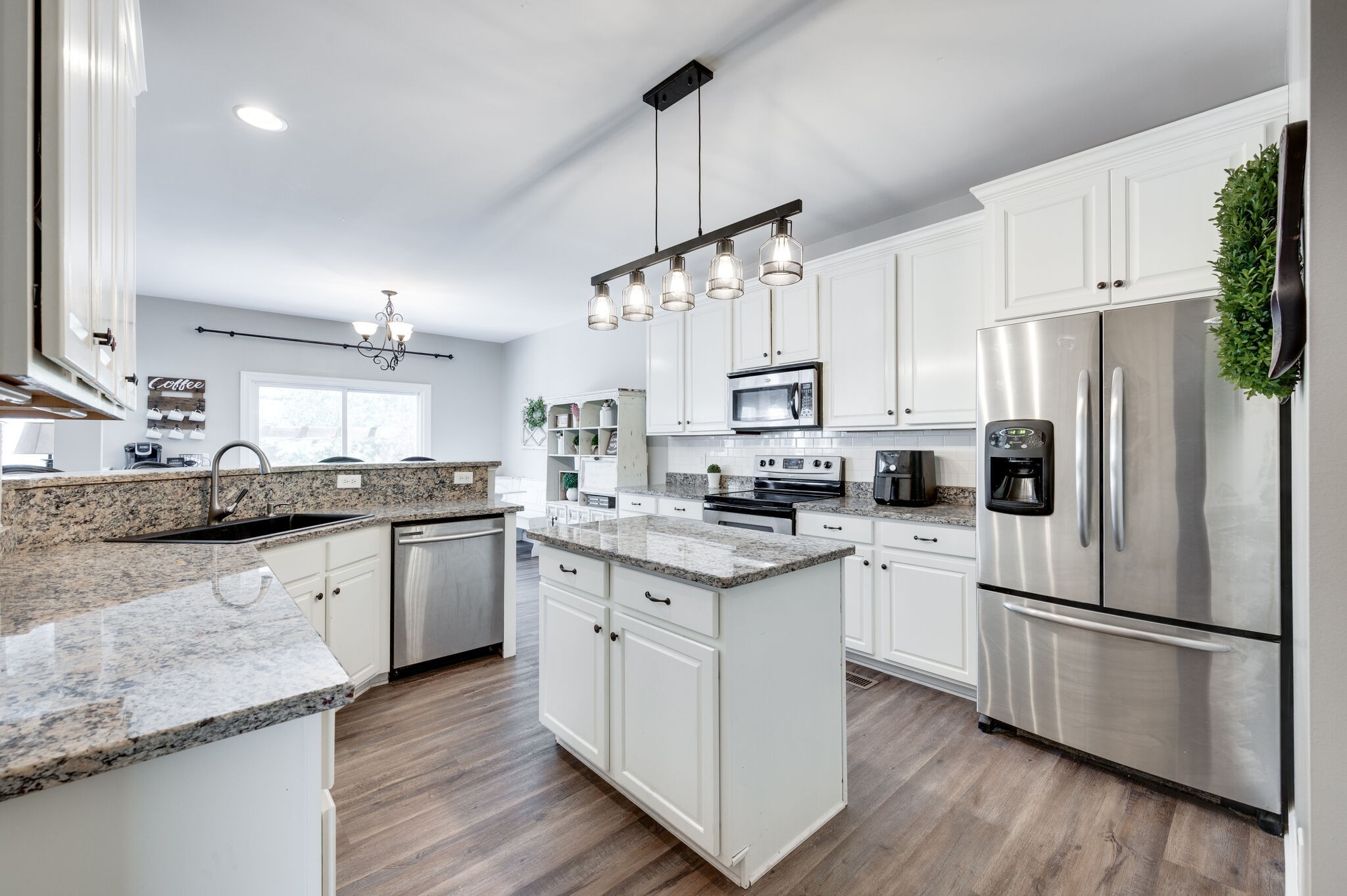 2047 Belshire Way Spring Hill, TN 37174 - Photo 24 of 54 a kitchen with stainless steel appliances granite countertop a refrigerator a sink dishwasher a stove and white countertops with wooden floor