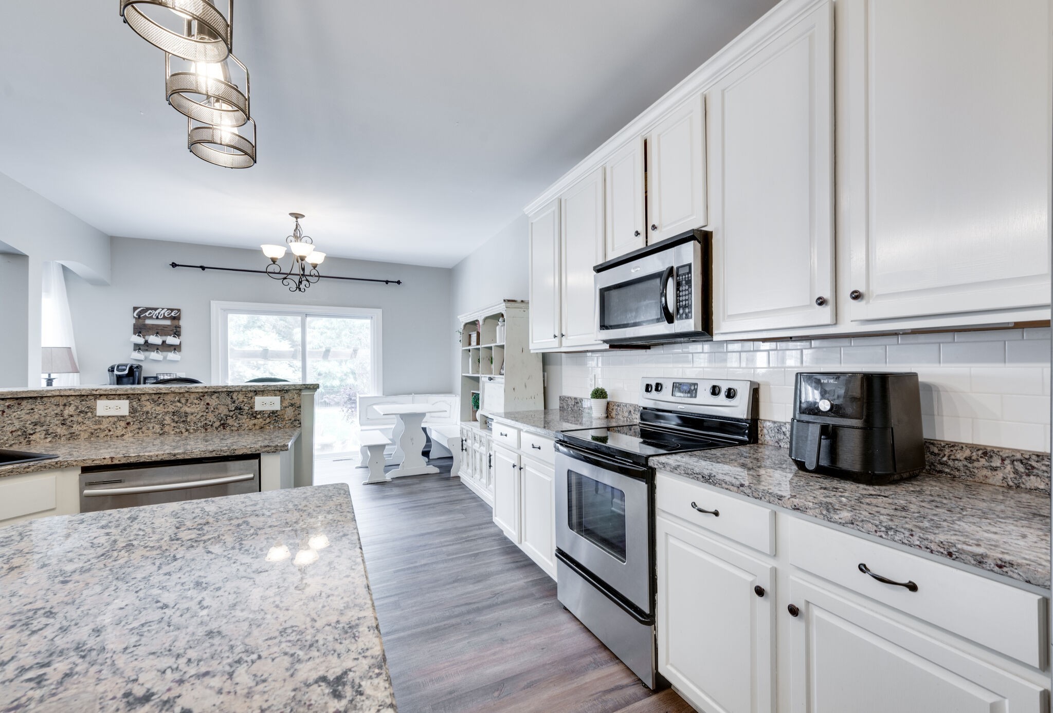 2047 Belshire Way Spring Hill, TN 37174 - Photo 25 of 54 a kitchen with stainless steel appliances granite countertop a stove top oven a sink dishwasher and a microwave oven with white cabinets