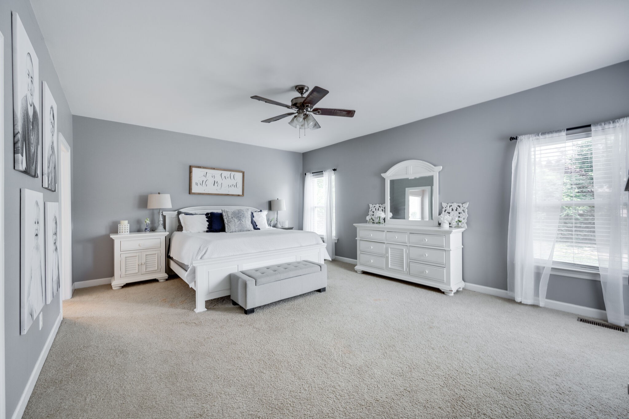 2047 Belshire Way Spring Hill, TN 37174 - Photo 28 of 54 a spacious bedroom with a bed a dresser and a chandelier