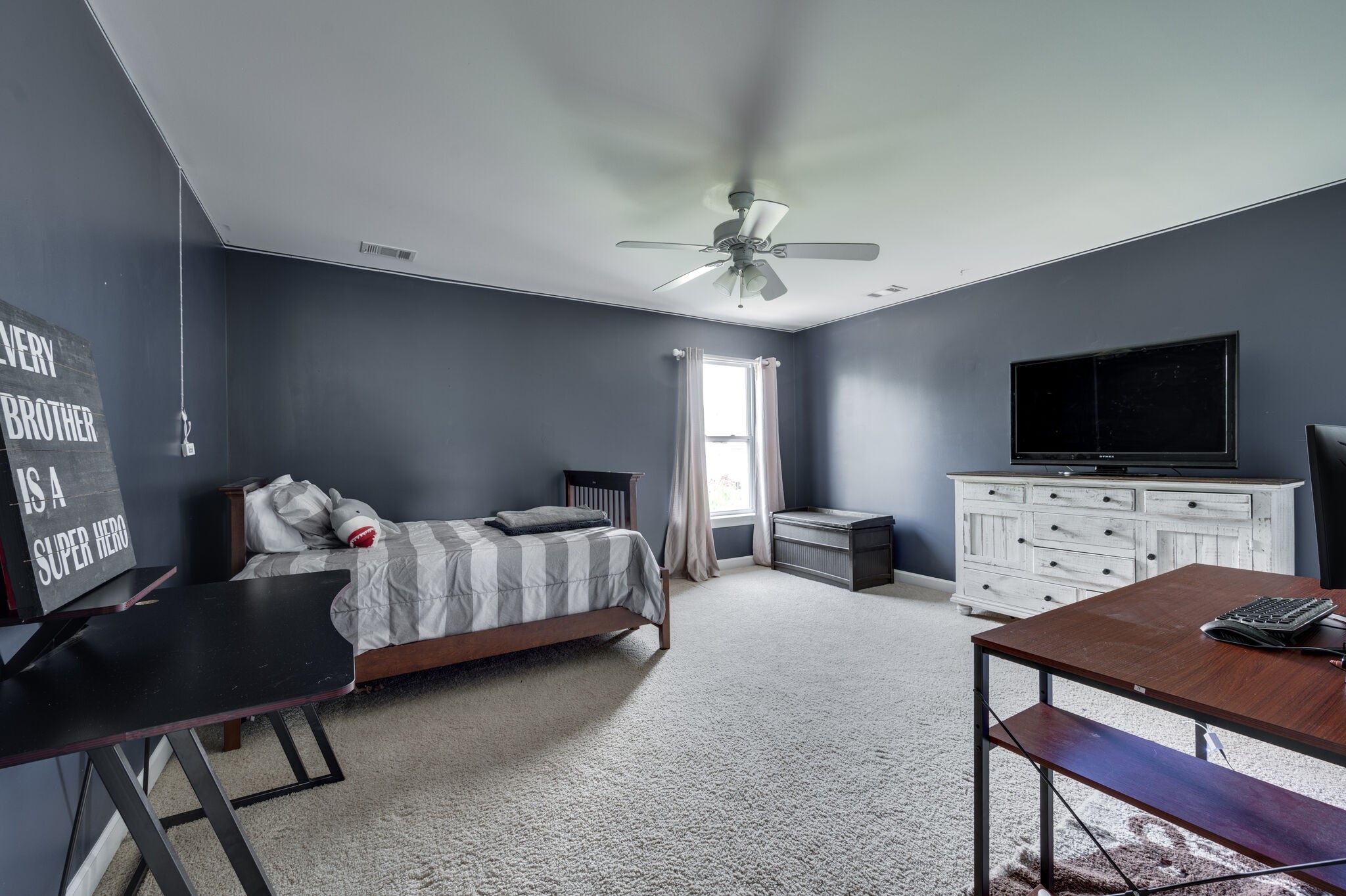 2047 Belshire Way Spring Hill, TN 37174 - Photo 37 of 54 a bedroom with furniture and a flat screen tv