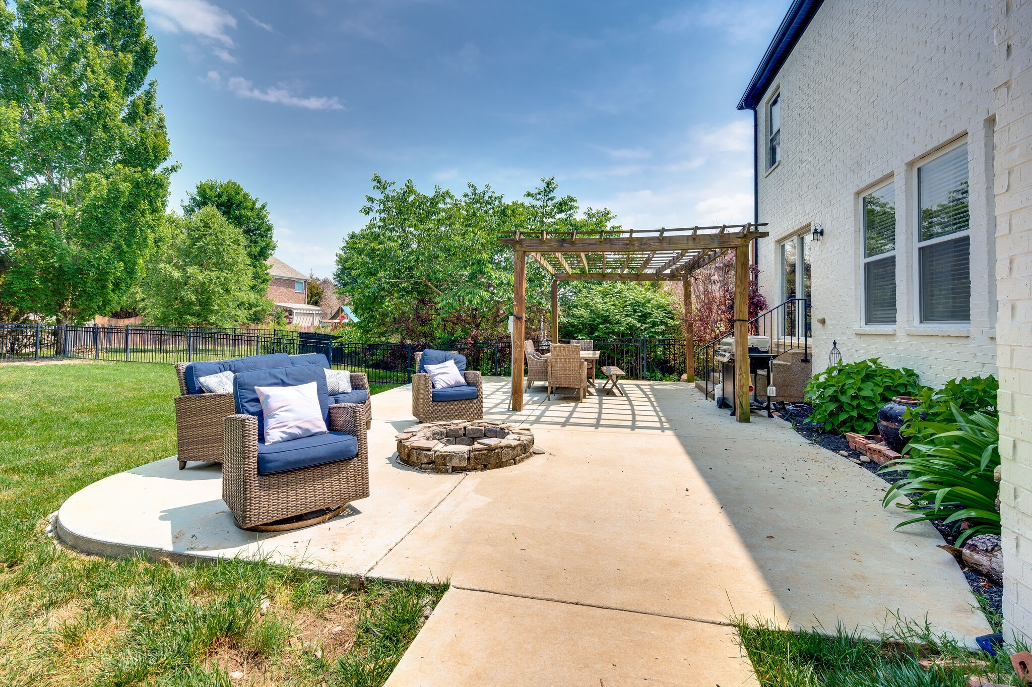 2047 Belshire Way Spring Hill, TN 37174 - Photo 44 of 54 a view of a patio with couches potted plants and a big yard