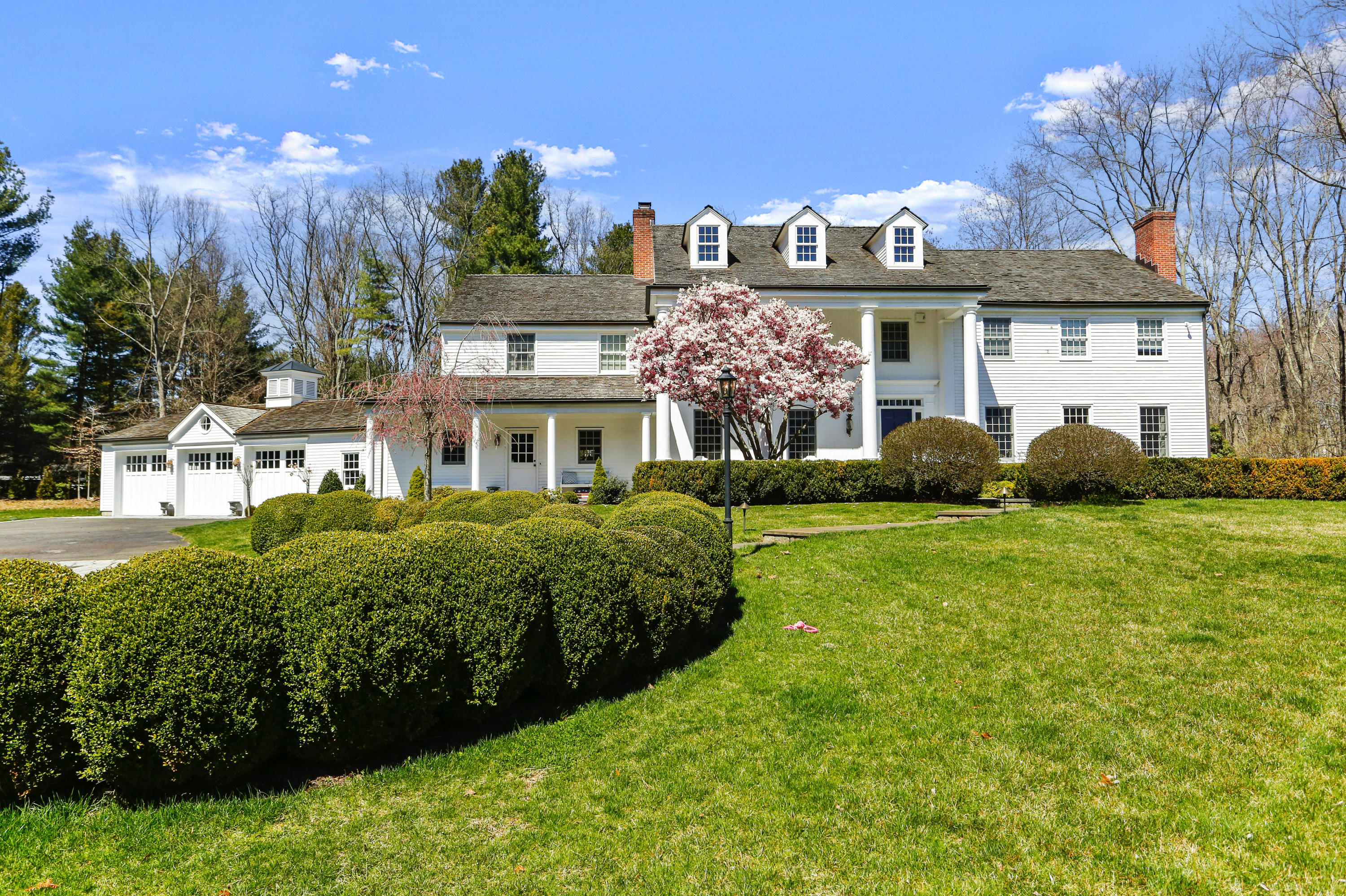 a front view of a house with a garden