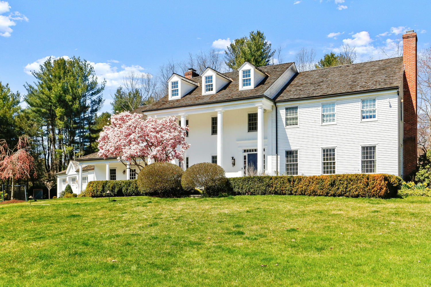 6 Hummingbird Lane Darien, CT 06820 - Photo 2 of 35 a front view of a house with a garden