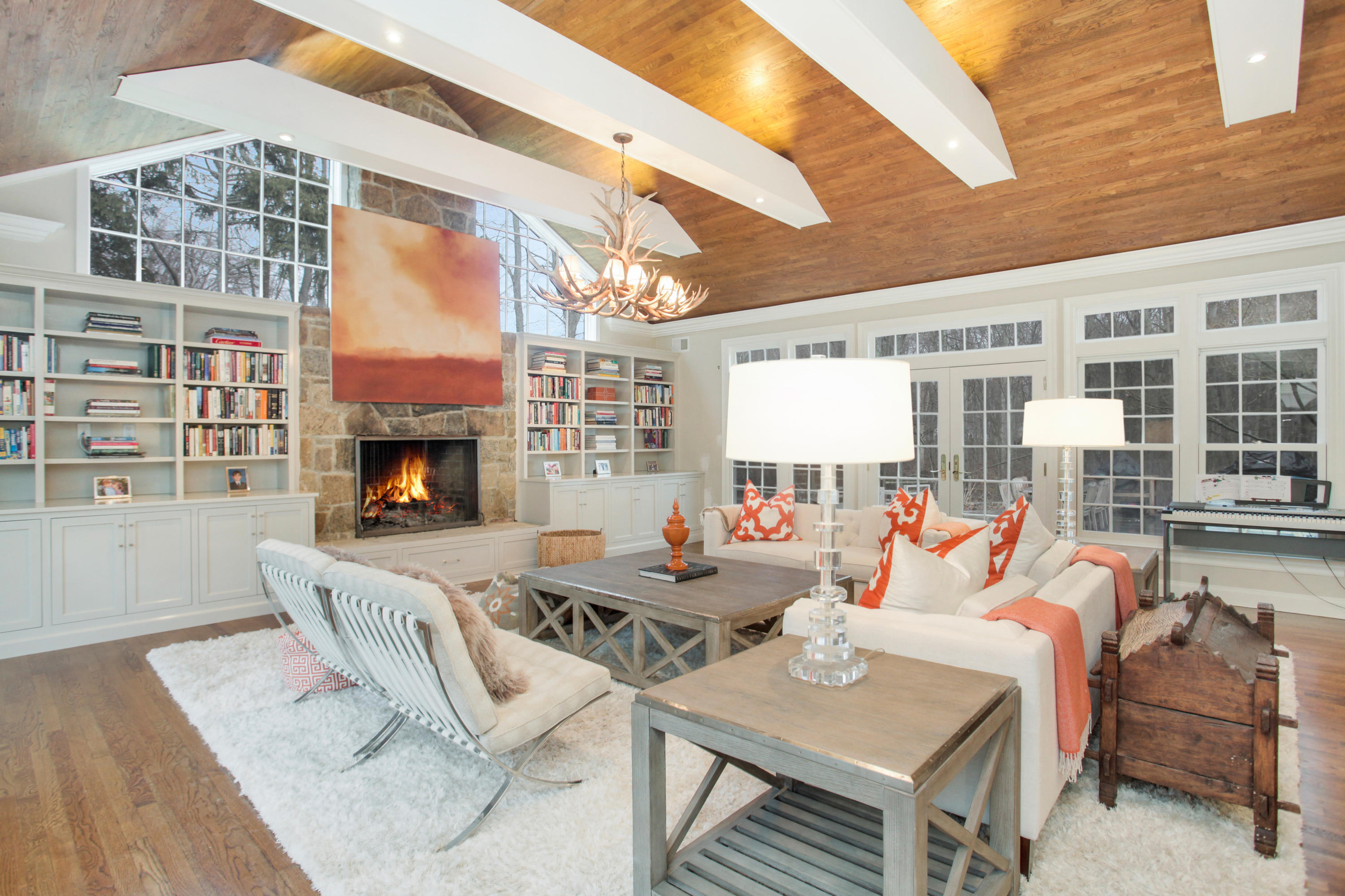 6 Hummingbird Lane Darien, CT 06820 - Photo 15 of 35 a living room with furniture a fireplace and a table