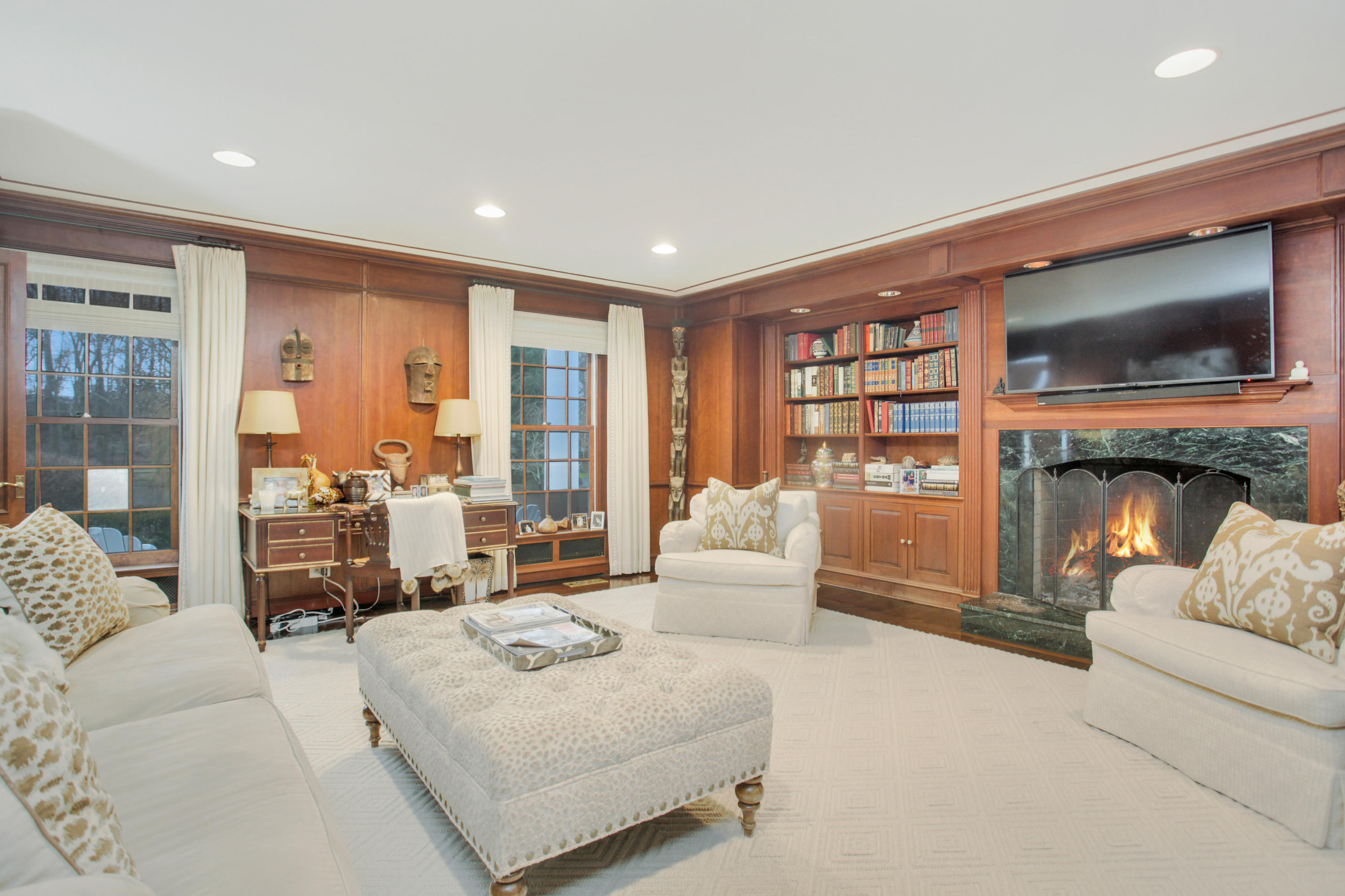 6 Hummingbird Lane Darien, CT 06820 - Photo 16 of 35 a living room with furniture fireplace and a flat screen tv