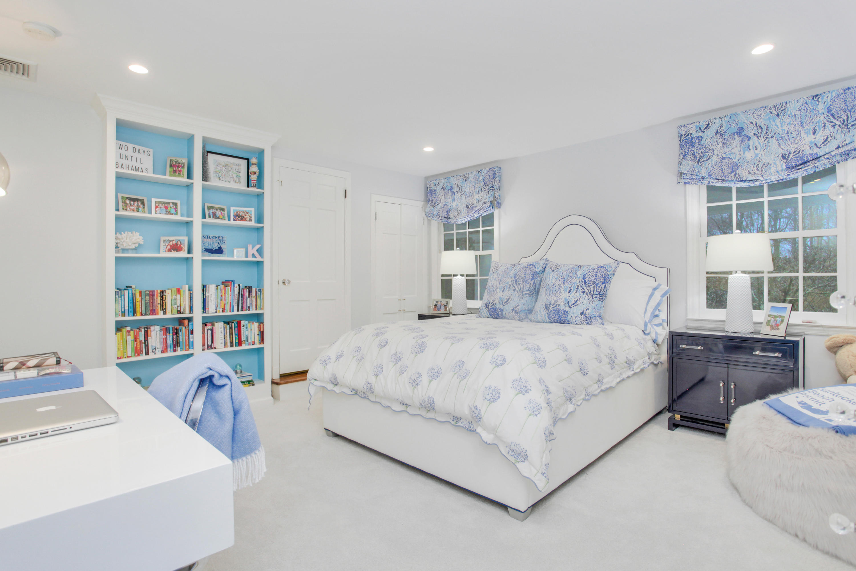 6 Hummingbird Lane Darien, CT 06820 - Photo 25 of 35 a bedroom with a large bed and a book shelf