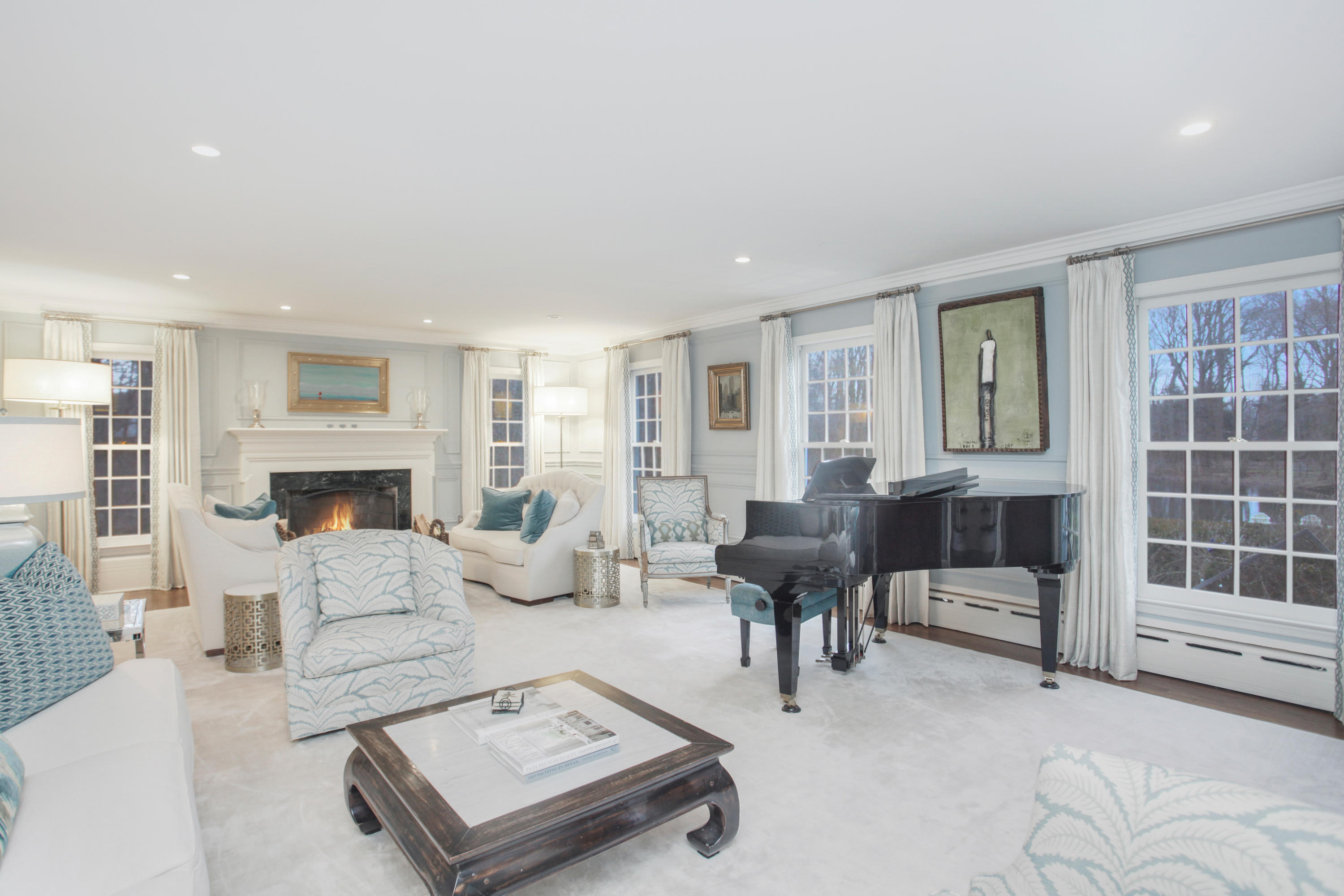 6 Hummingbird Lane Darien, CT 06820 - Photo 4 of 35 a living room with furniture a fireplace and a table