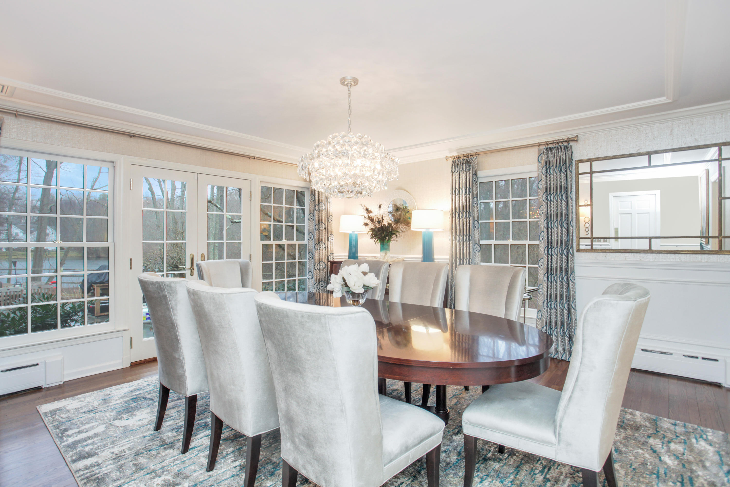 6 Hummingbird Lane Darien, CT 06820 - Photo 7 of 35 a view of a dining room with furniture wooden floor and a chandelier