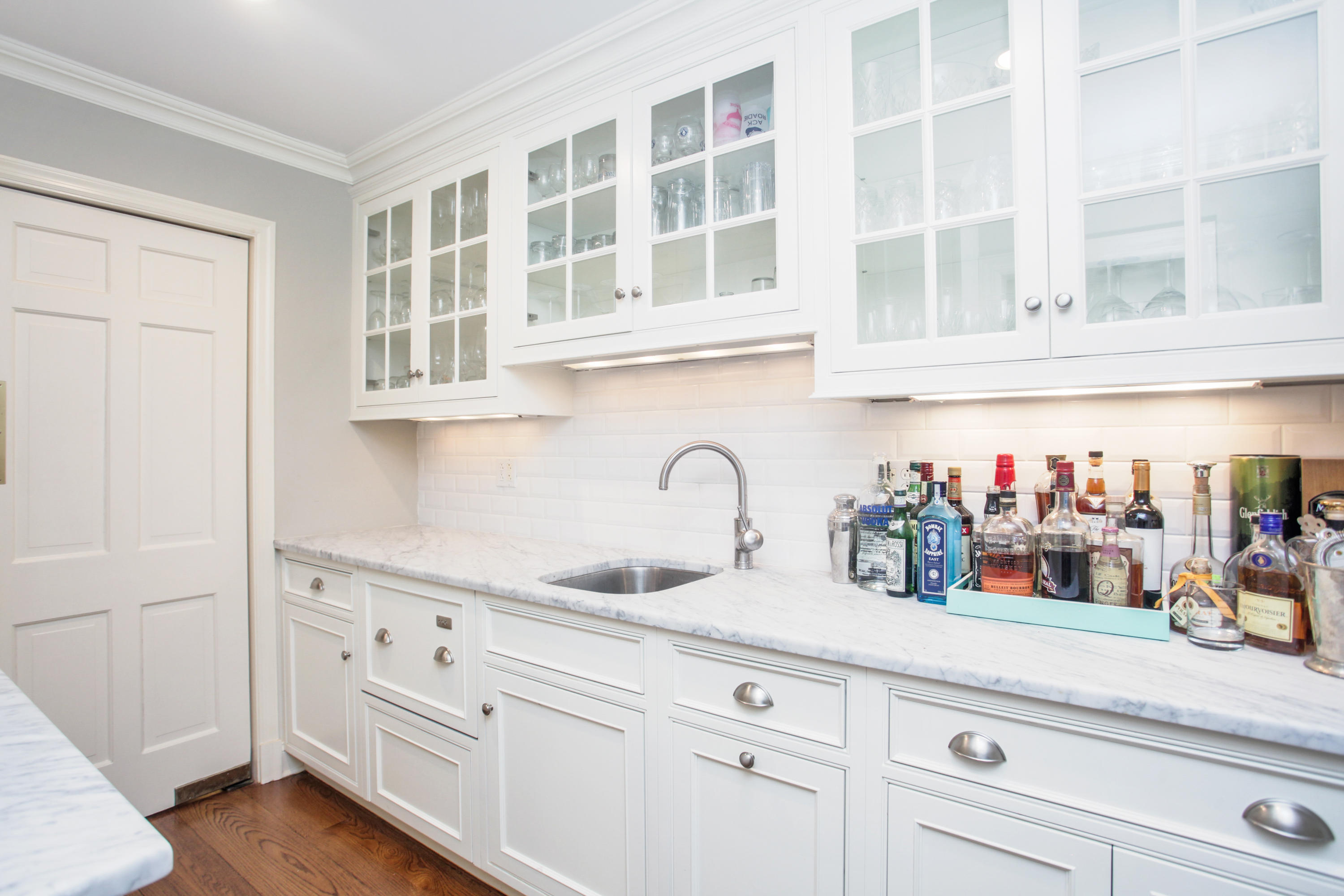6 Hummingbird Lane Darien, CT 06820 - Photo 9 of 35 a kitchen with white cabinets and sink