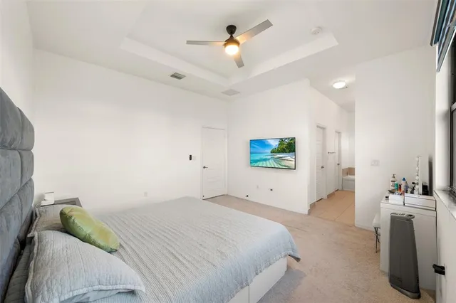 a bedroom with a bed and a chandelier