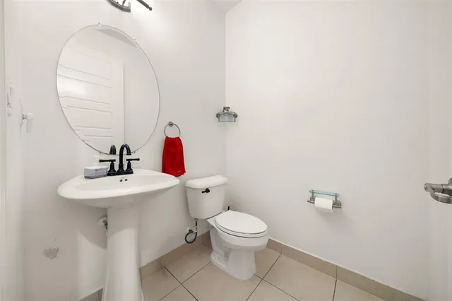 a white toilet sitting next to a bathroom sink