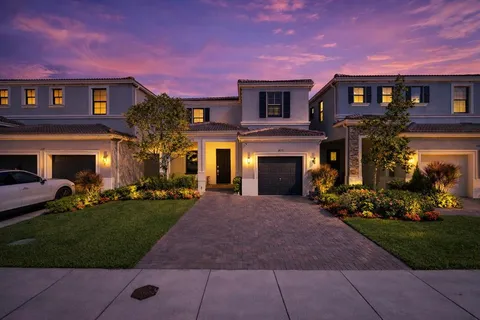 a front view of a house with a yard and a garage