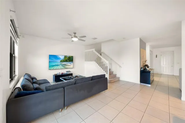 a living room with furniture and stairs