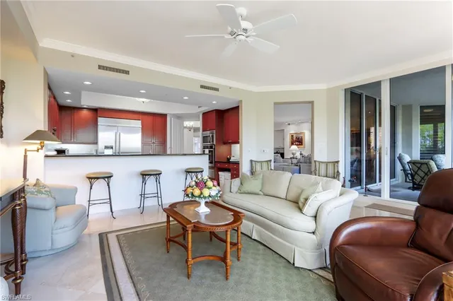 a living room with furniture and kitchen view