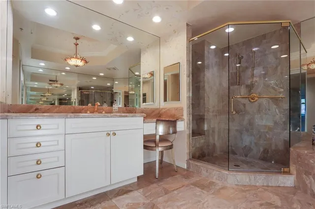 a bathroom with a shower a sink a toilet a mirror and shower