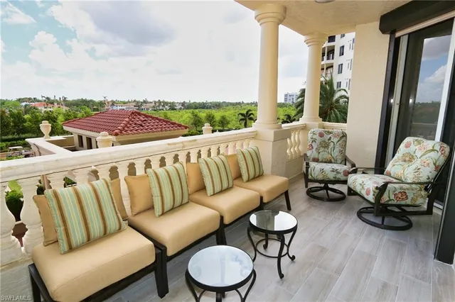 a balcony with outdoor seating and city view