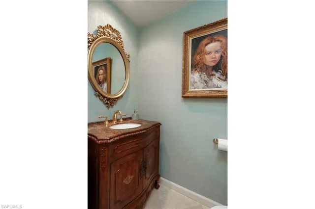 a bathroom with a sink a vanity and a mirror