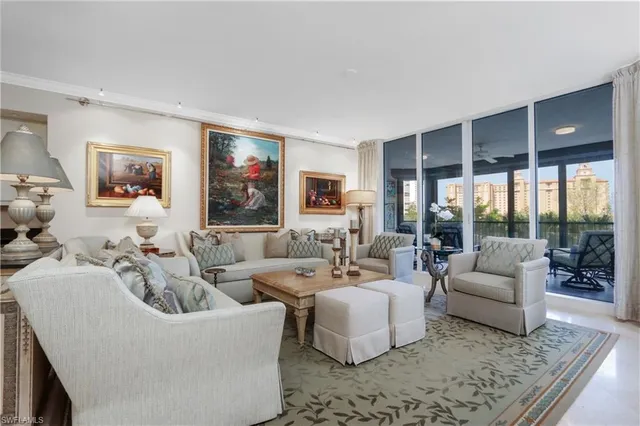 a living room with furniture and large windows