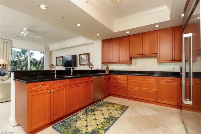 a large kitchen with stainless steel appliances granite countertop a sink and cabinets