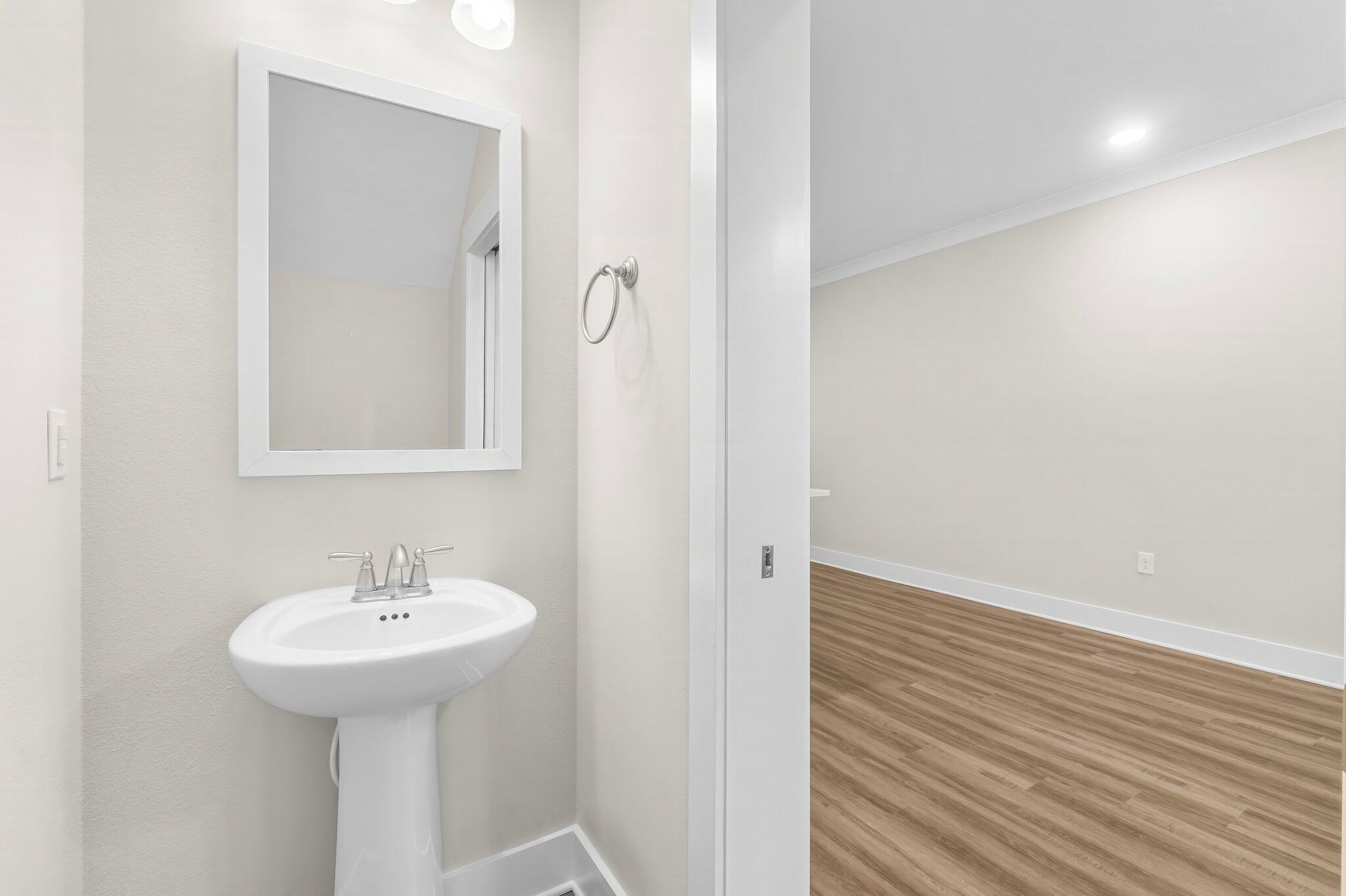 330 North Sand Palm Road, Unit VISTA Freeport, FL 32439 - Photo 11 of 38 a bathroom with a sink and a mirror