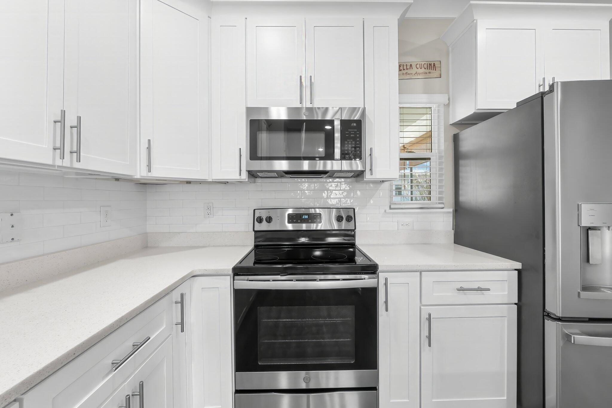 330 North Sand Palm Road, Unit VISTA Freeport, FL 32439 - Photo 13 of 38 a kitchen with cabinets stainless steel appliances and a counter space