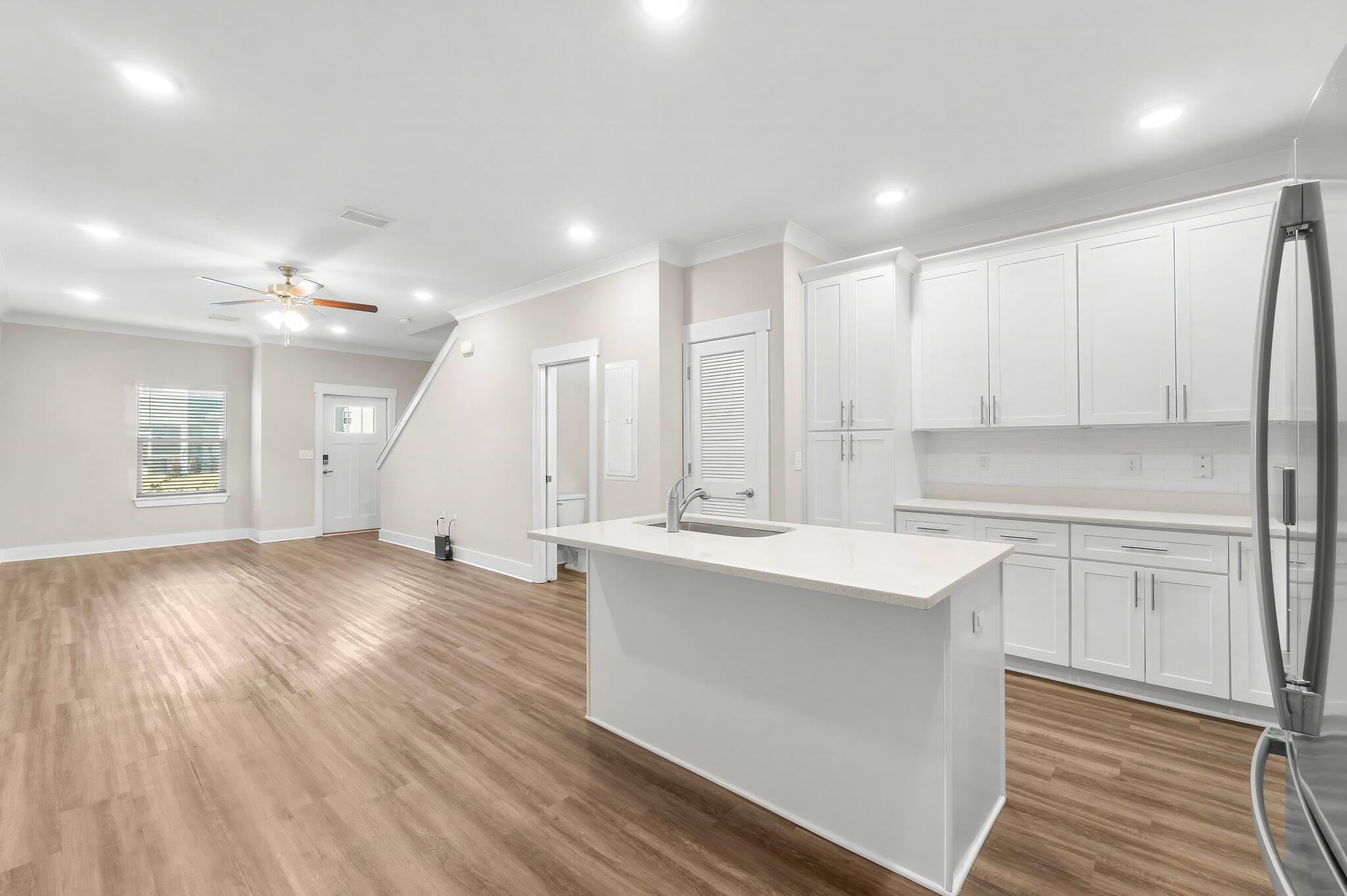 330 North Sand Palm Road, Unit VISTA Freeport, FL 32439 - Photo 16 of 38 a kitchen with stainless steel appliances granite countertop a sink a stove a refrigerator and island with wooden floor