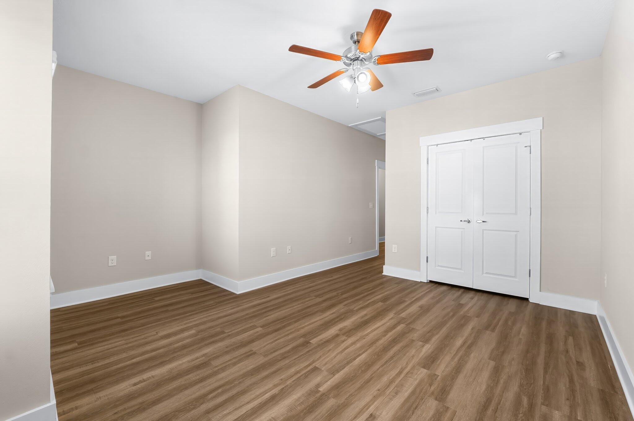 330 North Sand Palm Road, Unit VISTA Freeport, FL 32439 - Photo 20 of 38 an empty room with wooden floor and windows
