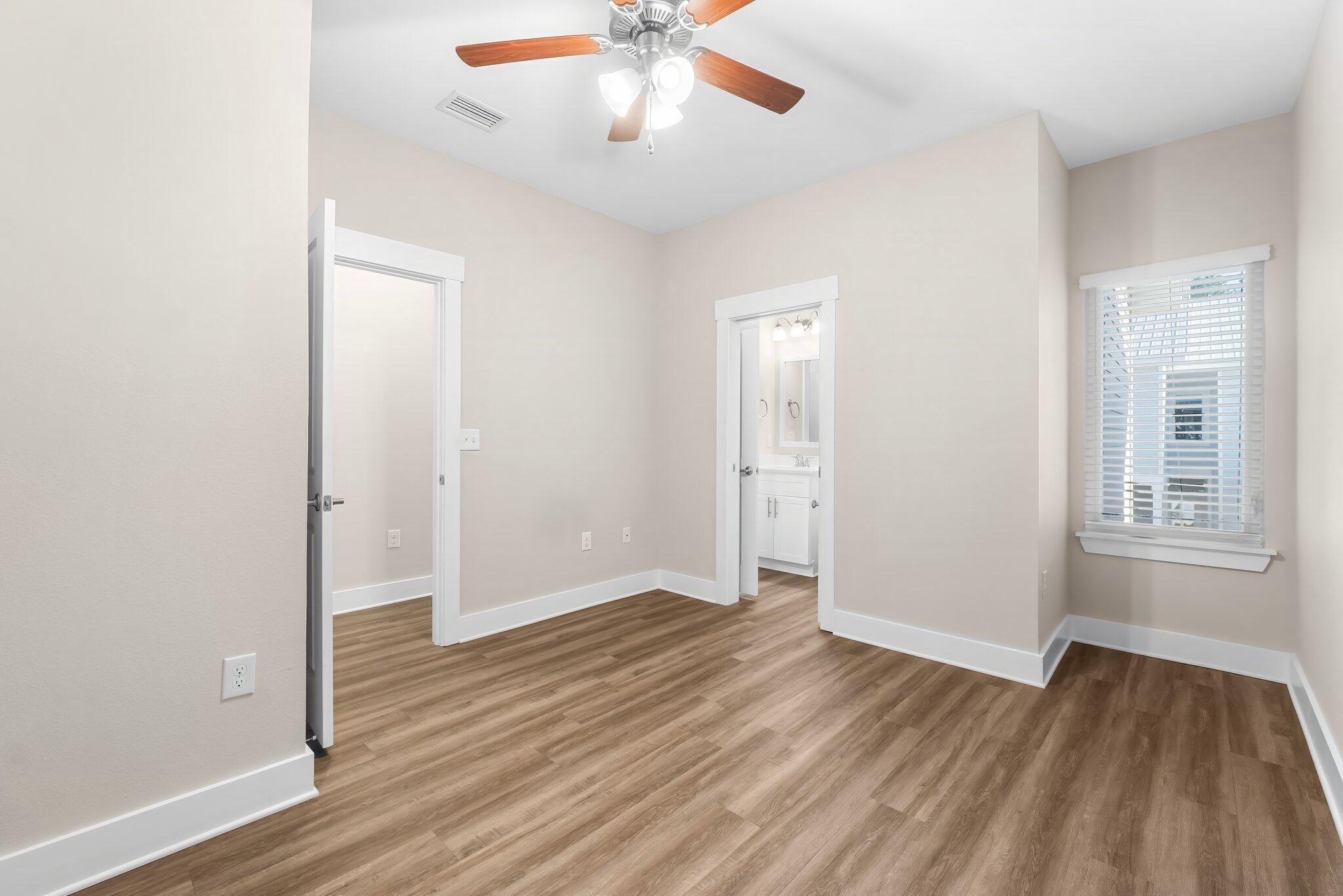 330 North Sand Palm Road, Unit VISTA Freeport, FL 32439 - Photo 23 of 38 an empty room with wooden floor and windows