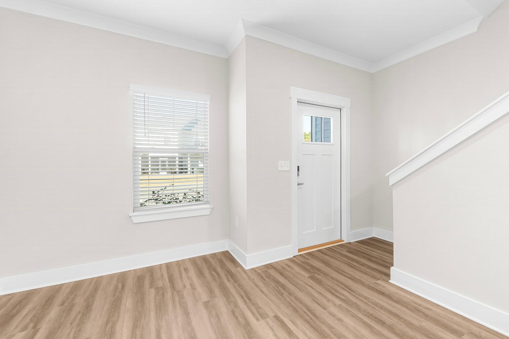 330 North Sand Palm Road, Unit VISTA Freeport, FL 32439 - Photo 5 of 38 a view of an empty room with wooden floor and a window