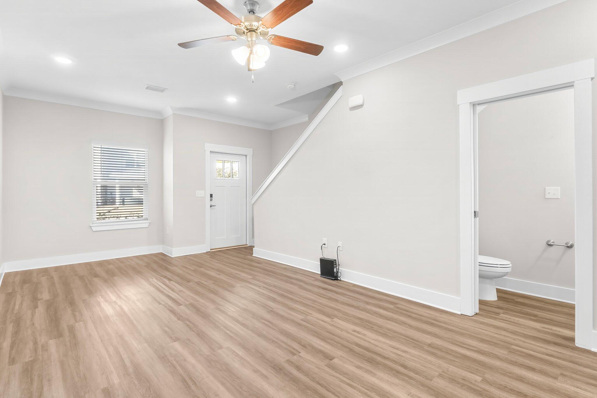 330 North Sand Palm Road, Unit VISTA Freeport, FL 32439 - Photo 9 of 38 an empty room with wooden floor and windows