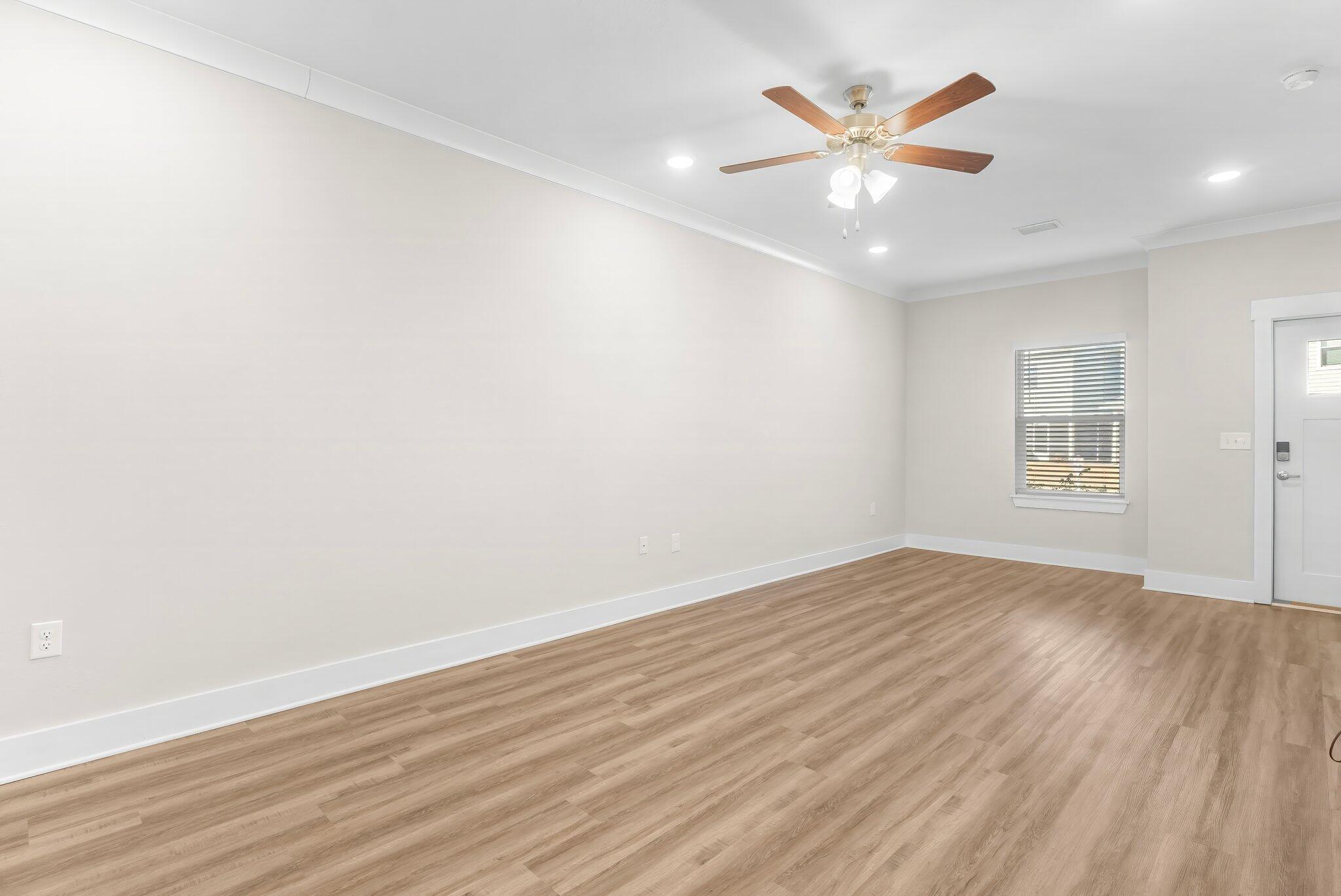 330 North Sand Palm Road, Unit VISTA Freeport, FL 32439 - Photo 10 of 38 an empty room with wooden floor and windows