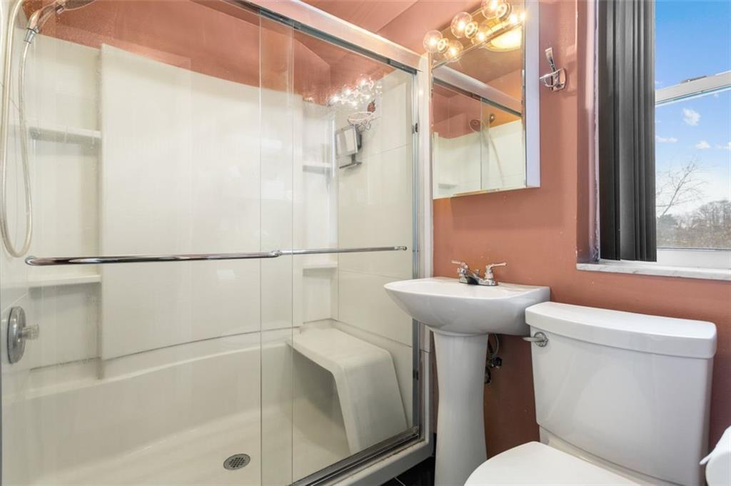 812 Rolling Rock Road Pittsburgh, PA 15234 - Photo 16 of 24 Hallway bathroom with surround shower and sliding glass doors.