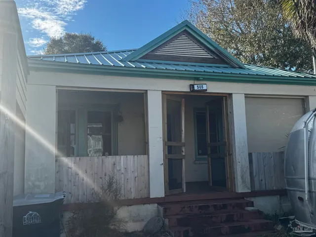 a view of a porch with furniture and a fireplace