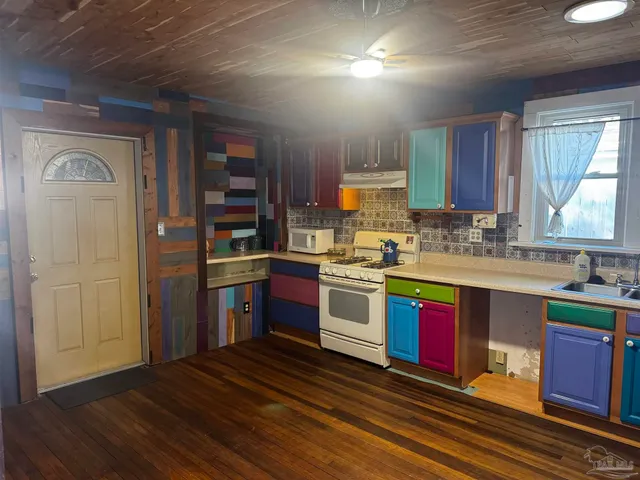 a utility room with closet and a rug