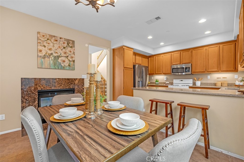 3377 Drome Lane Riverside, CA 92503 - Photo 8 of 42 Dual facing fireplace makes for a cozy meal