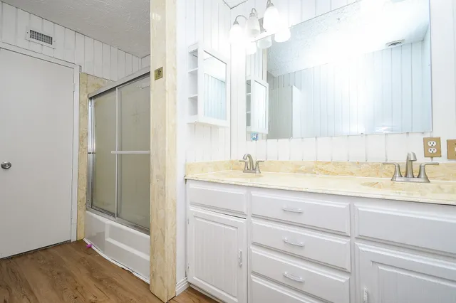 a bathroom with a sink a vanity and a mirror