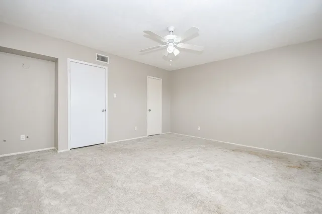 a view of an empty room with a fan