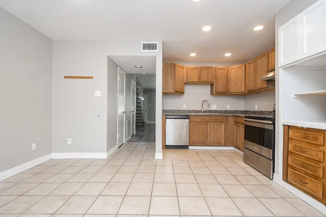 a kitchen with a stove a sink and a refrigerator