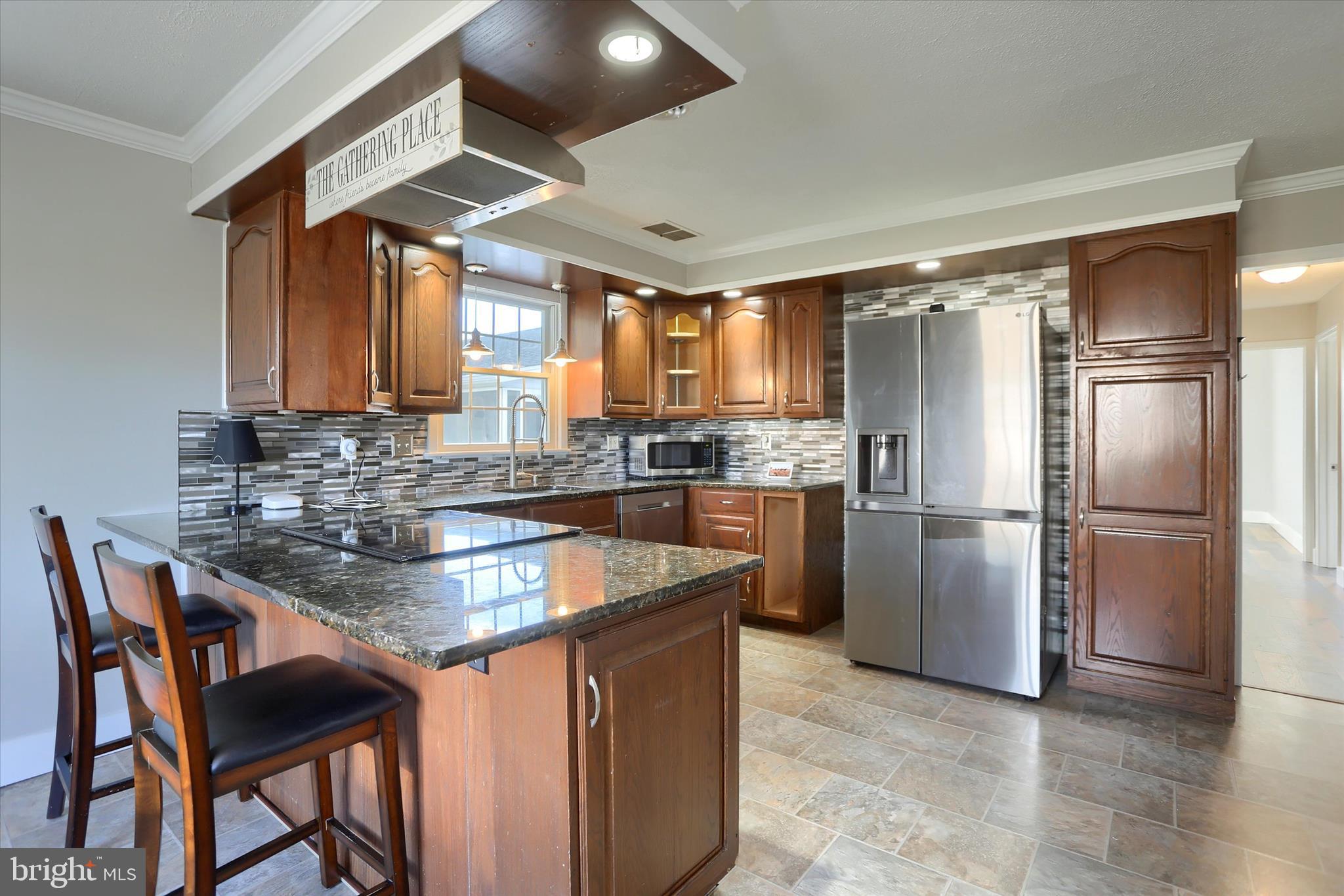 302 Park Road Valley View, PA 17983 - Photo 12 of 59 a kitchen with stainless steel appliances granite countertop a sink a stove and a refrigerator