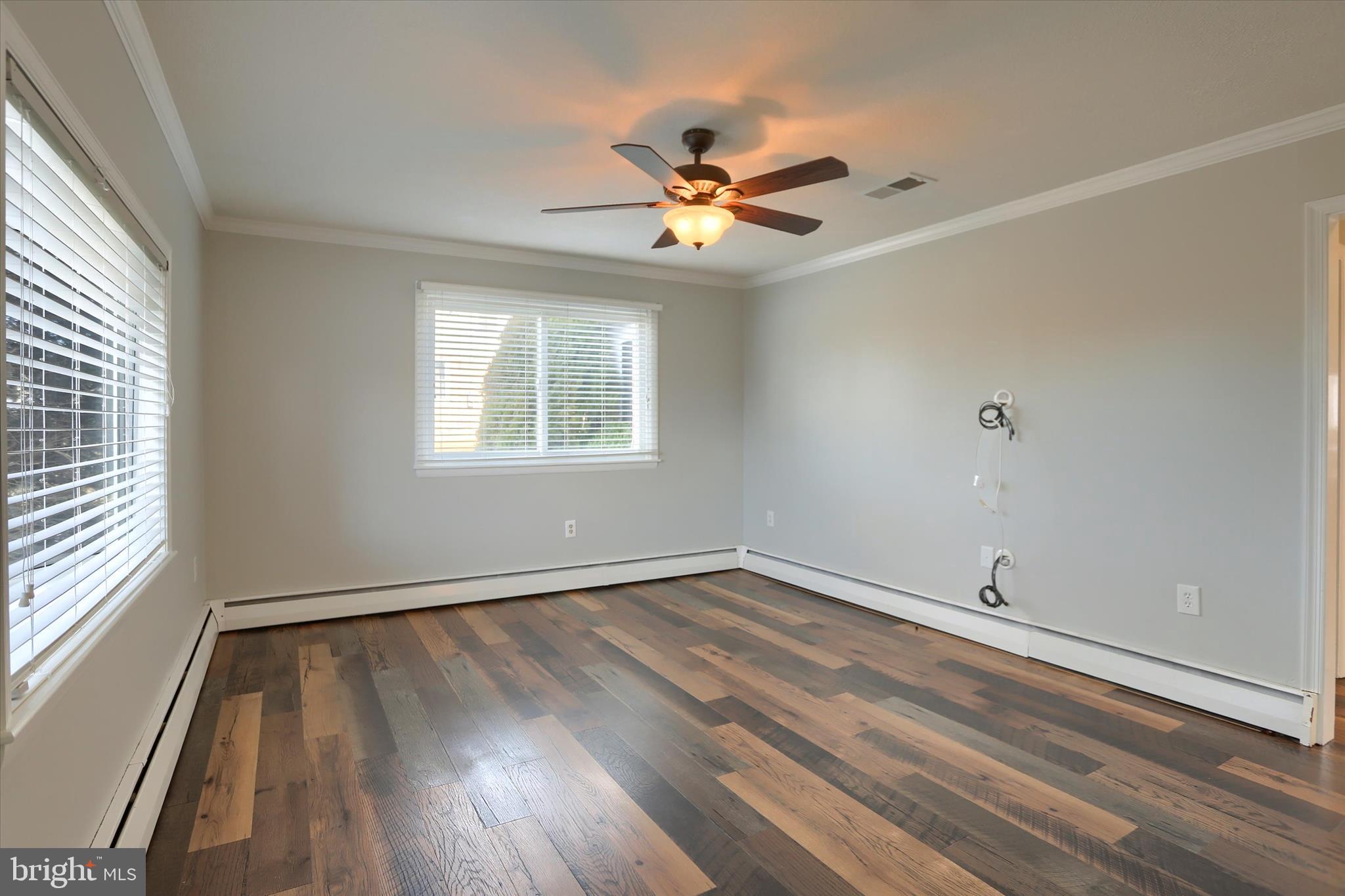 302 Park Road Valley View, PA 17983 - Photo 5 of 59 an empty room with wooden floor fan and windows