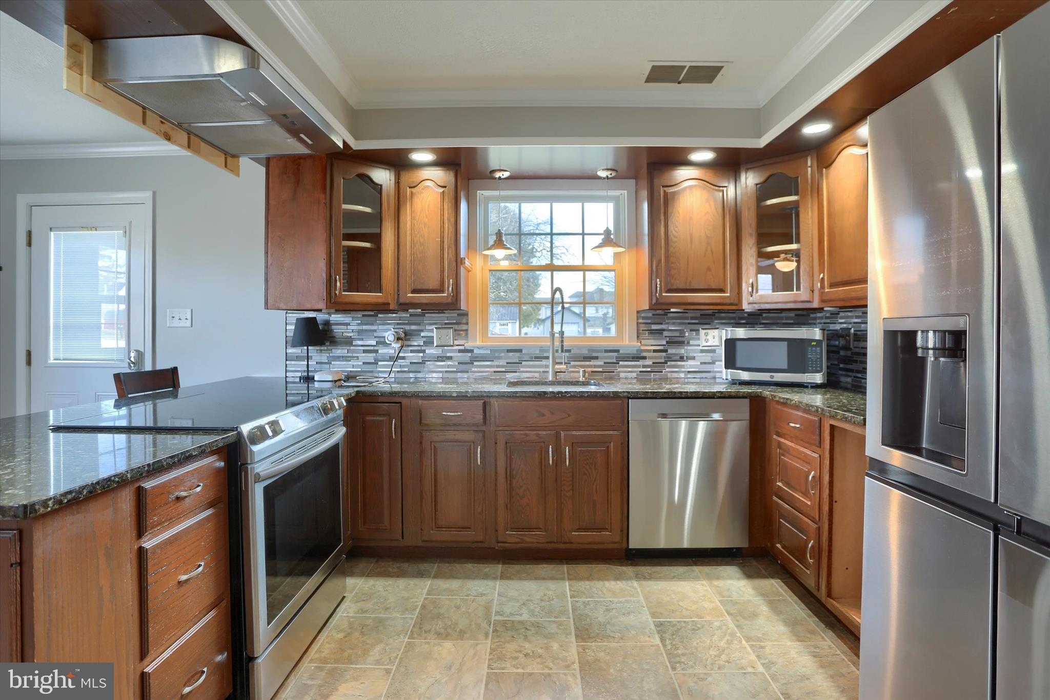 302 Park Road Valley View, PA 17983 - Photo 9 of 59 a kitchen with stainless steel appliances granite countertop a sink stove and refrigerator