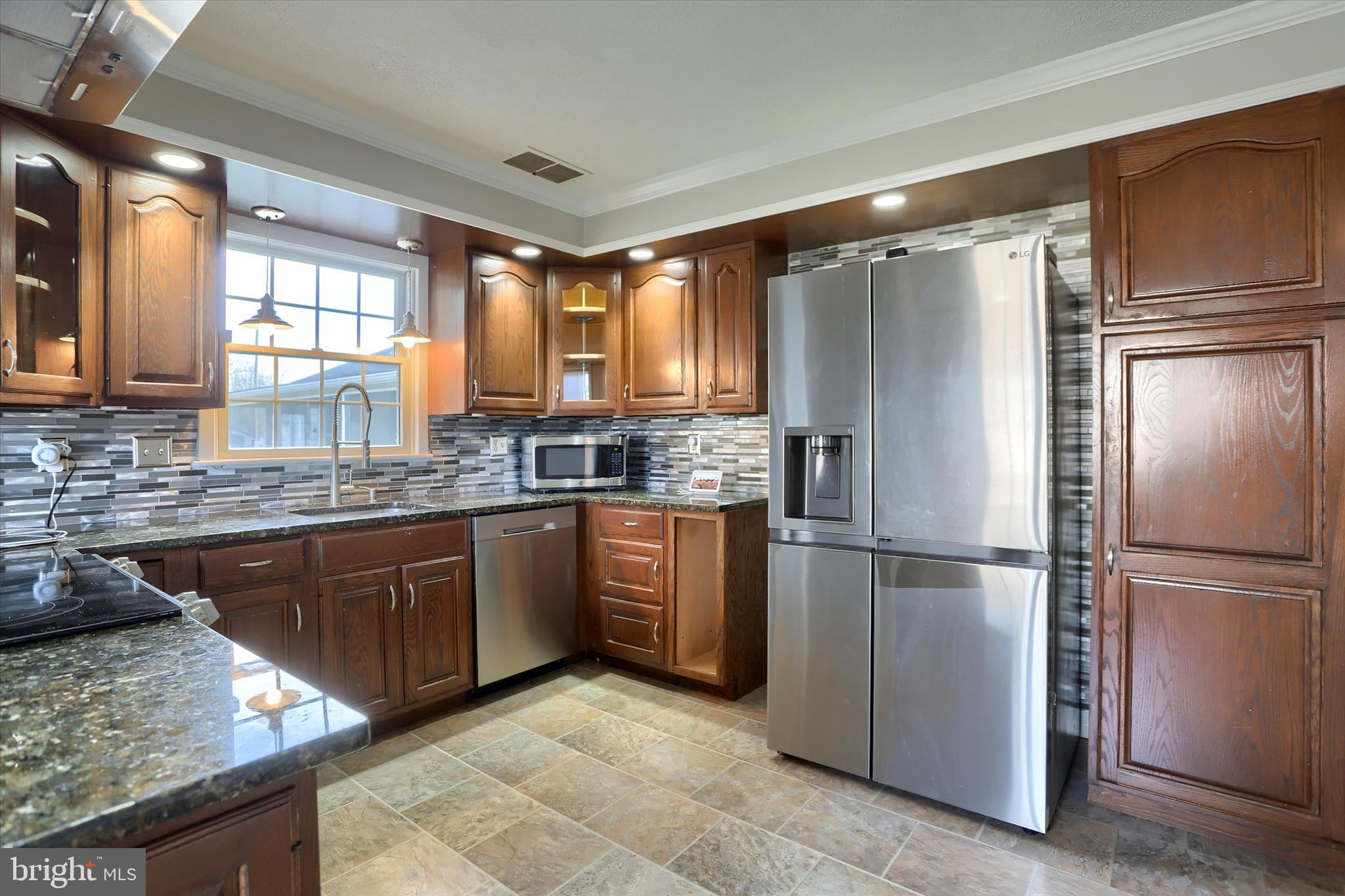 302 Park Road Valley View, PA 17983 - Photo 10 of 59 a kitchen with stainless steel appliances granite countertop a refrigerator a sink a stove a microwave and island
