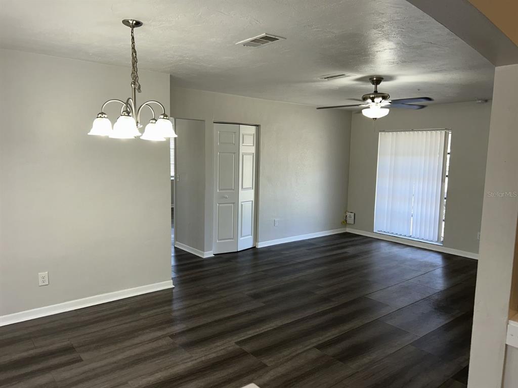 1241 Pilgrim Road Spring Hill, FL 34606 - Photo 4 of 28 a view of a room with wooden floor and windows