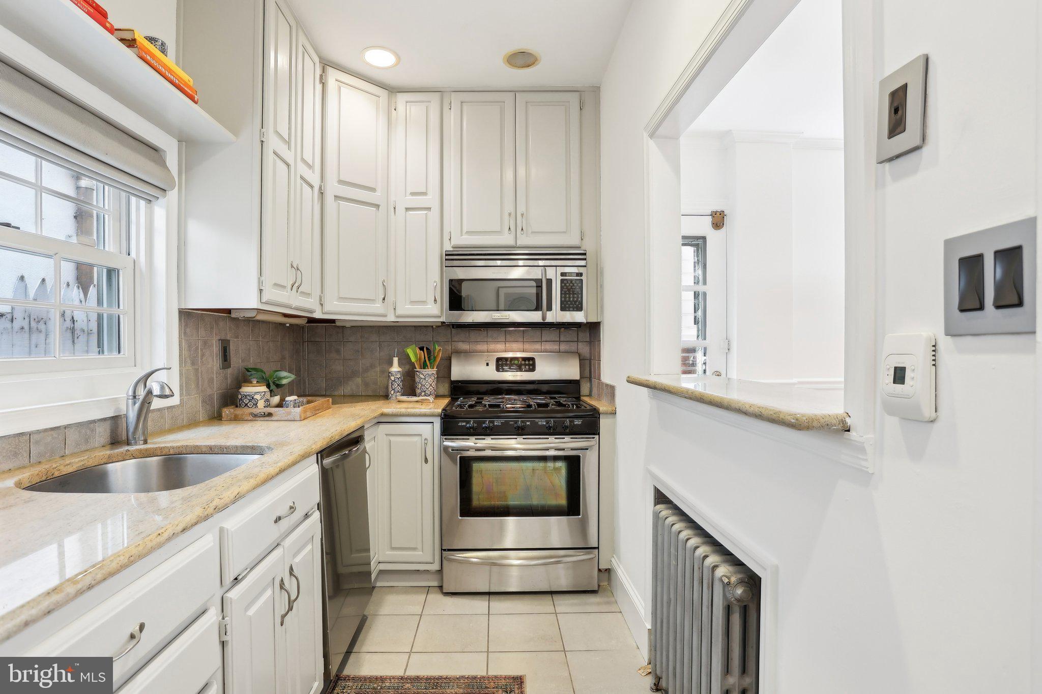321 South Smedley Street Philadelphia, PA 19103 - Photo 11 of 39 a kitchen with stainless steel appliances granite countertop a sink and a stove