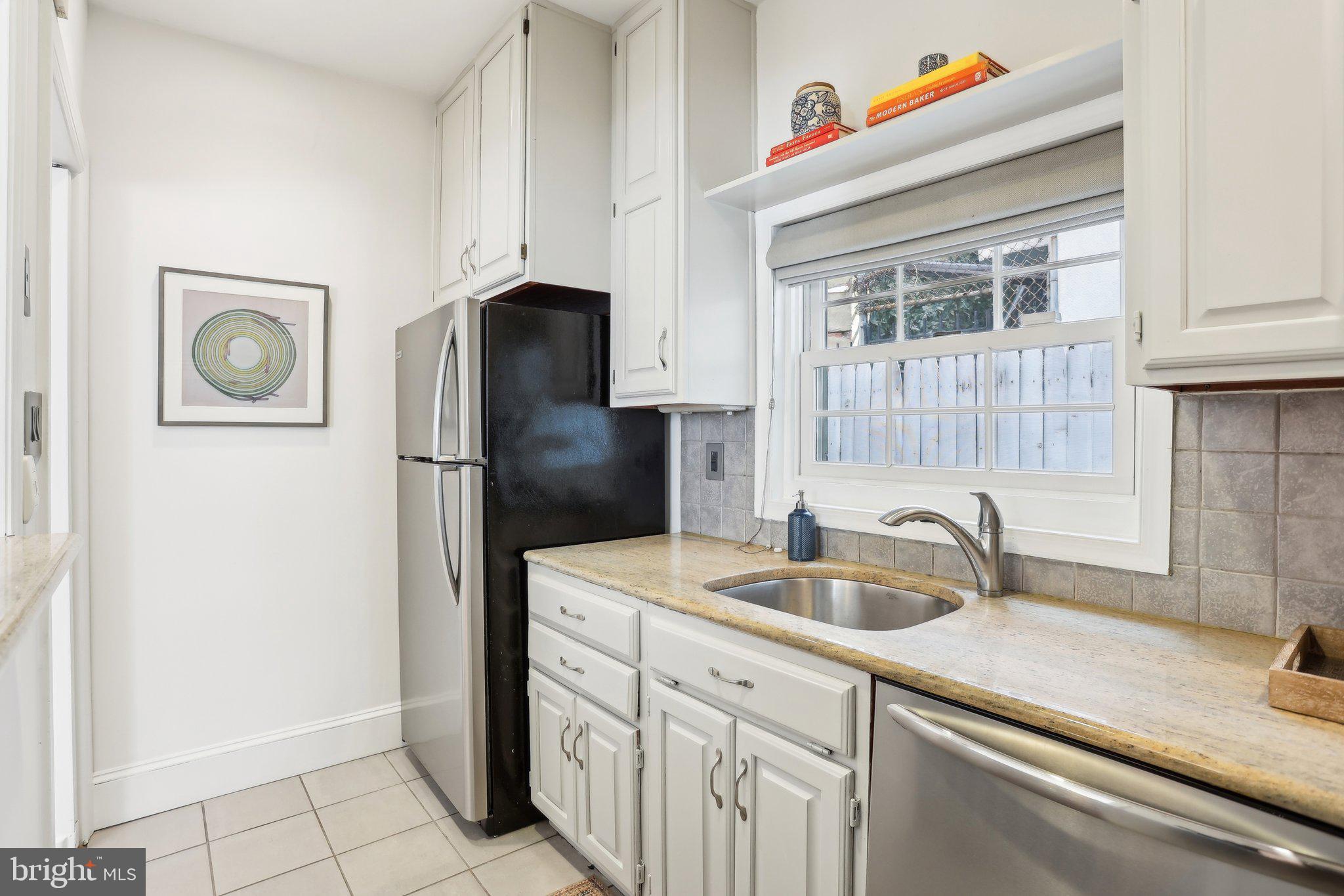 321 South Smedley Street Philadelphia, PA 19103 - Photo 12 of 39 a kitchen with cabinets and a refrigerator