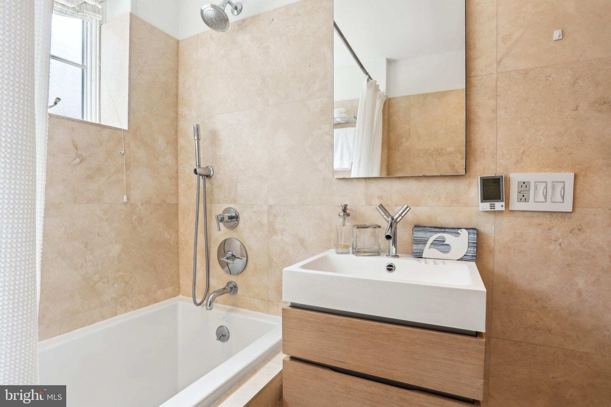 321 South Smedley Street Philadelphia, PA 19103 - Photo 25 of 39 a bathroom with a sink a bathtub and a shower